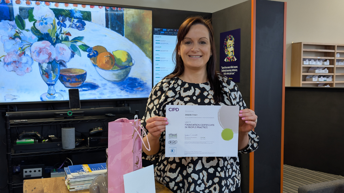 Woman holding professional certificate in modern office